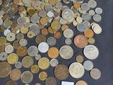 a pile of coins sitting on a table next to a sign