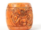 an orange vase with a carved design of a woman and a child