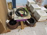 a pile of boxes and wires on a pallet in a room