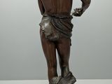 an image of a statue of a man standing on a rock