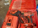 a red tool box with tools in it on a table