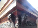 a close up view of a wooden structure with carvings on it