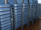 many blue chairs lined up in a row in a room