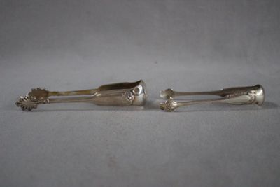 pair of silver plated spoons on a white surface