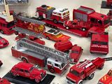 a lot of toy fire trucks and other toys on the table