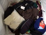 a pile of clothes in a plastic bag on the floor