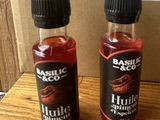 two bottles of liquid sitting on top of a table next to a cardboard box