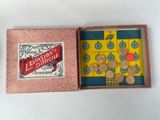 a small box with buttons in it on a table