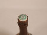 a close up of a bottle of beer on a table