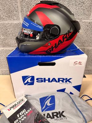 a shark helmet on top of a box with other items