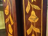 two tall wooden vases with flowers painted on them