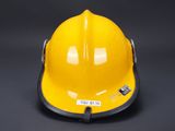 a close up of a yellow hard hat on a black background