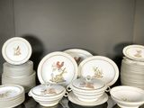 a lot of plates and bowls sitting on a table