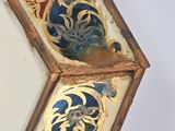 a mirror that has a design on the side of it
