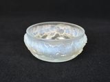 a small glass bowl with a lacy design on it
