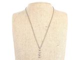 a necklace with a diamond pendant on a mannequin neck