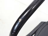 a close up view of a black chair with a rusted handle