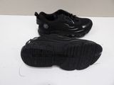 pair of black sneakers on a white surface with a white background