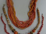 necklace made of multi - colored beads and wooden beads on a white surface