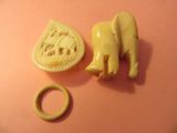 a small elephant and a ring on a pink surface