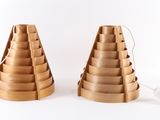 two wooden lamps that are on a white surface