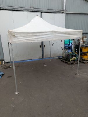 a white tent that is set up in front of a building