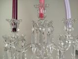 three glass candles that are sitting on a table