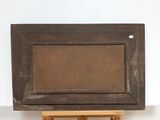 painting on a wooden easel in front of a white wall