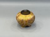 a small vase with a design on it on a white surface