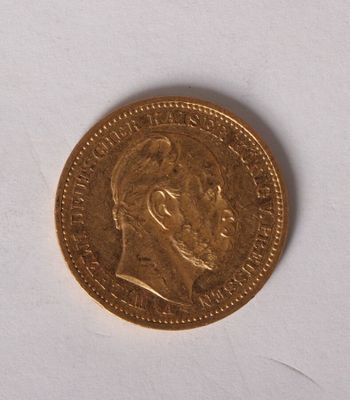 a close up of a gold coin on a white surface