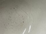 a white bowl sitting on top of a black table