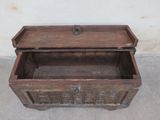 a wooden box with a lid on a cement floor