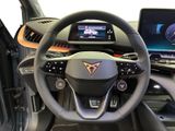 a steering wheel and dashboard of a car with a laptop in the background