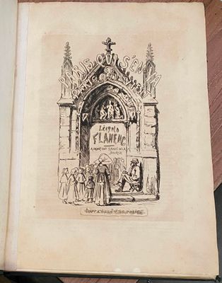 un vieux livre orné d'un dessin, posé sur une table