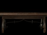 a wooden table with metal legs on a black background