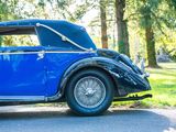 a blue vintage car parked on the side of the road