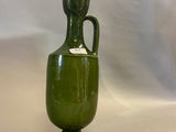a green vase that is connected to a computer mouse