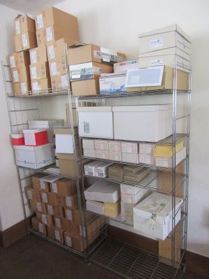 a metal shelving with many boxes and boxes on it