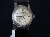 a watch that is sitting on a black table