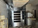 a kitchen with a checkered floor and a stove and oven