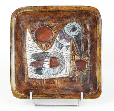brown and blue ceramic plate with a design of fish on it