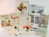many old books and postcards on a table
