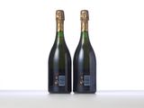 two bottles of champagne sitting on top of a table