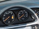 a close up of a car dashboard with gauges and speedometers