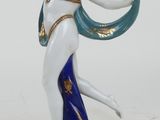 an image of a figurine of a woman holding a blue and white scarf