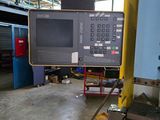 a picture of a machine in a factory with a large monitor on it