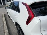 a white car parked on the side of the street