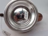 a person taking a picture of a silver cup