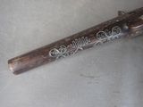 a wooden stick with writing on it sitting on a table