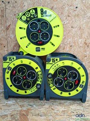 two yellow and black clocks sitting on top of a wooden table
